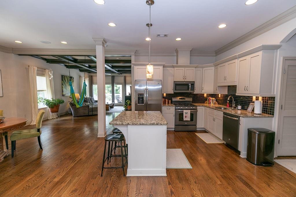 1084 Sanders Avenue Southeast, Unit A Atlanta, GA 30316 - Photo 7 of 44 an open kitchen with wooden floor and stainless steel appliances