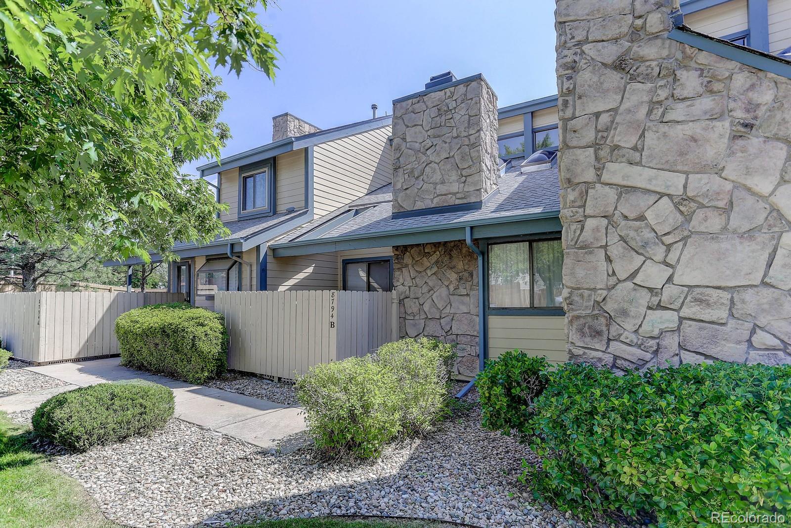 8794 Allison Drive, Unit B Arvada, CO 80005 - Photo 1 of 33 a front view of a house with garden