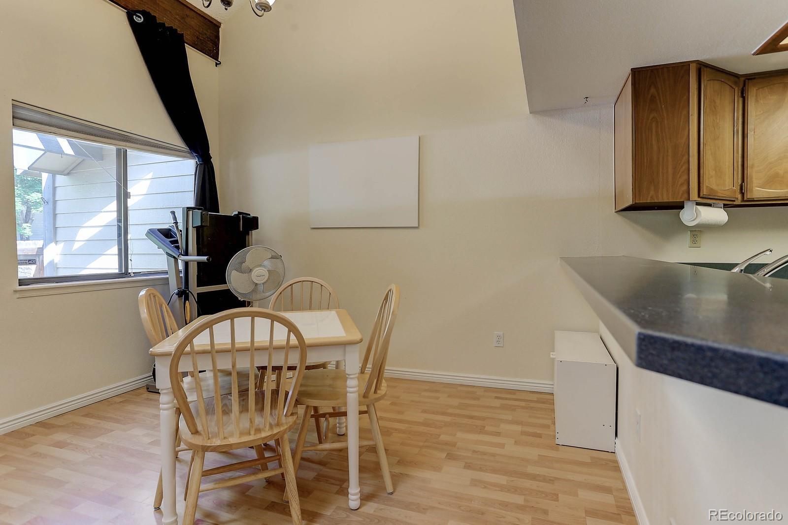 8794 Allison Drive, Unit B Arvada, CO 80005 - Photo 11 of 33 a view of a dining room with furniture and a potted plant