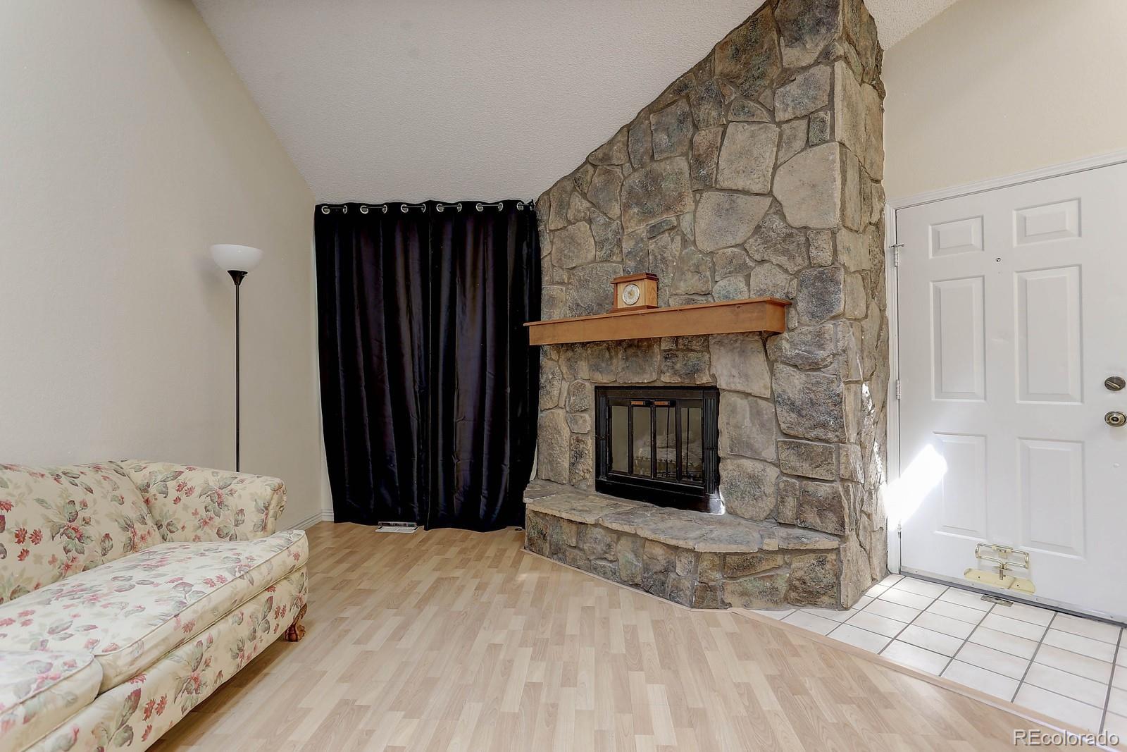 8794 Allison Drive, Unit B Arvada, CO 80005 - Photo 13 of 33 a living room with a couch and a fireplace