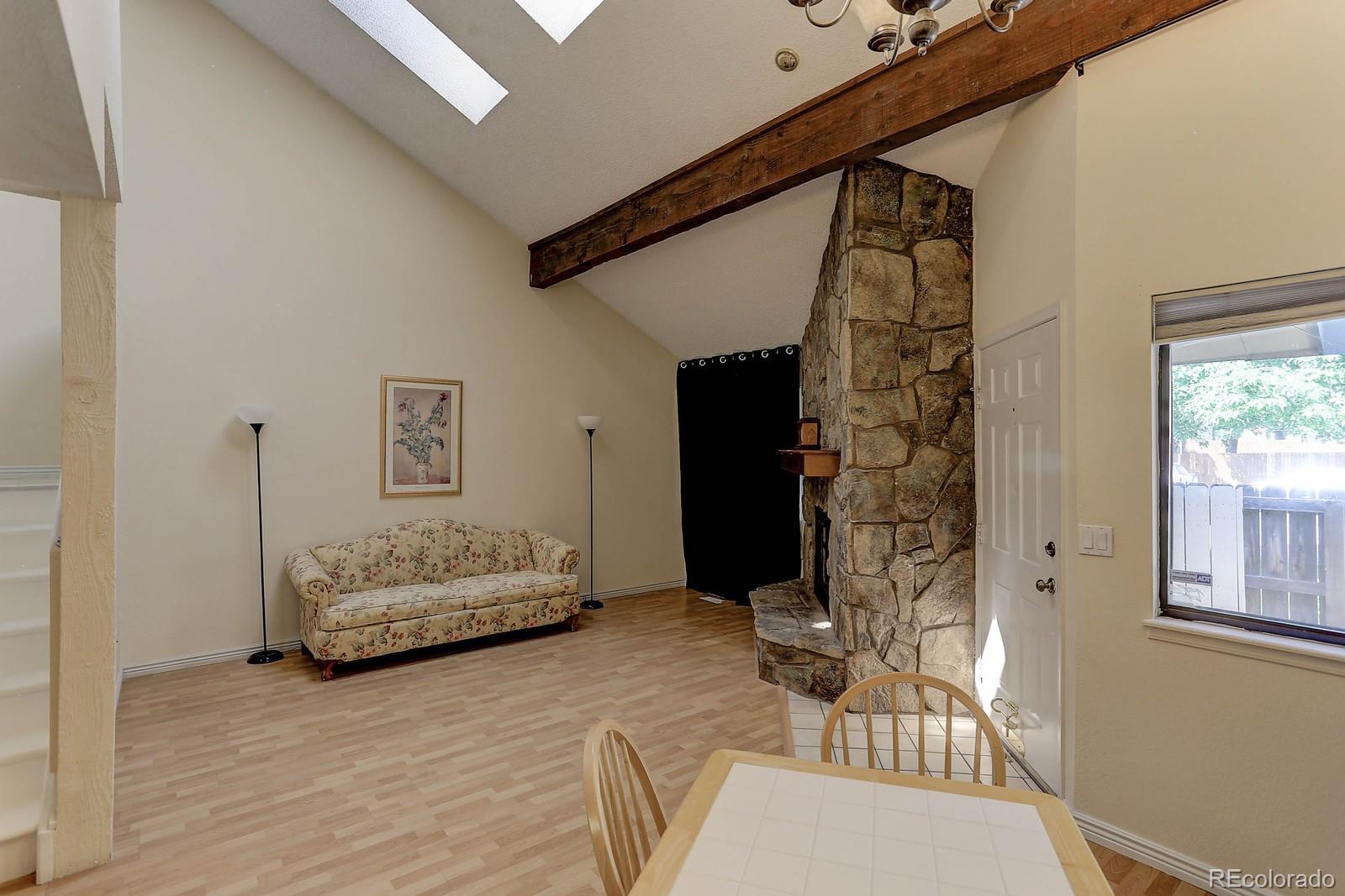 8794 Allison Drive, Unit B Arvada, CO 80005 - Photo 14 of 33 a bedroom with a bed and a mirror