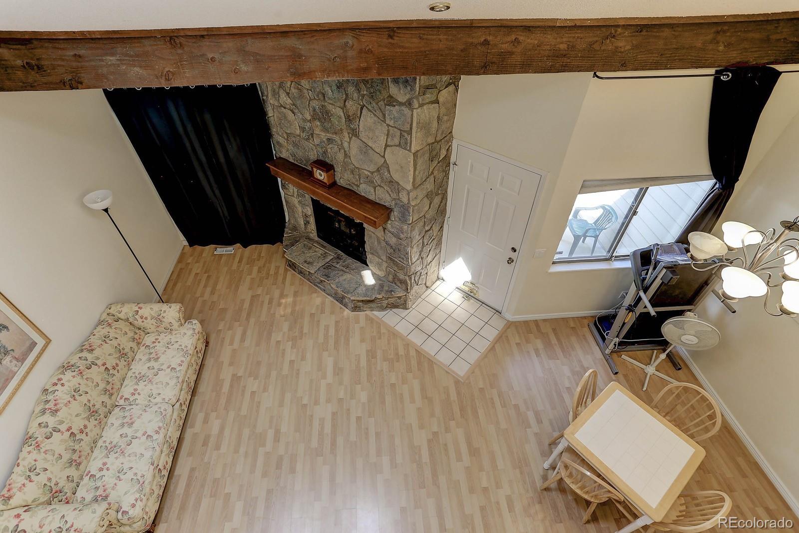 8794 Allison Drive, Unit B Arvada, CO 80005 - Photo 17 of 33 view of living room with furniture and a fireplace