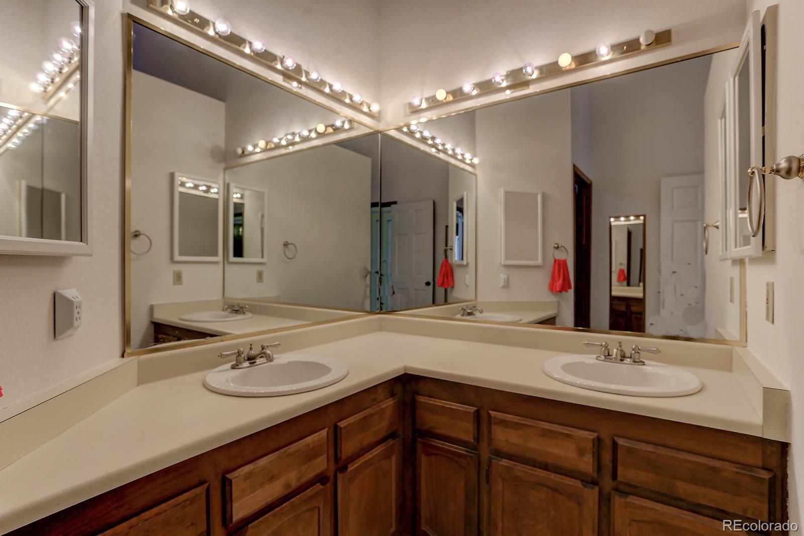 8794 Allison Drive, Unit B Arvada, CO 80005 - Photo 20 of 33 a bathroom with a sink double vanity and a mirror