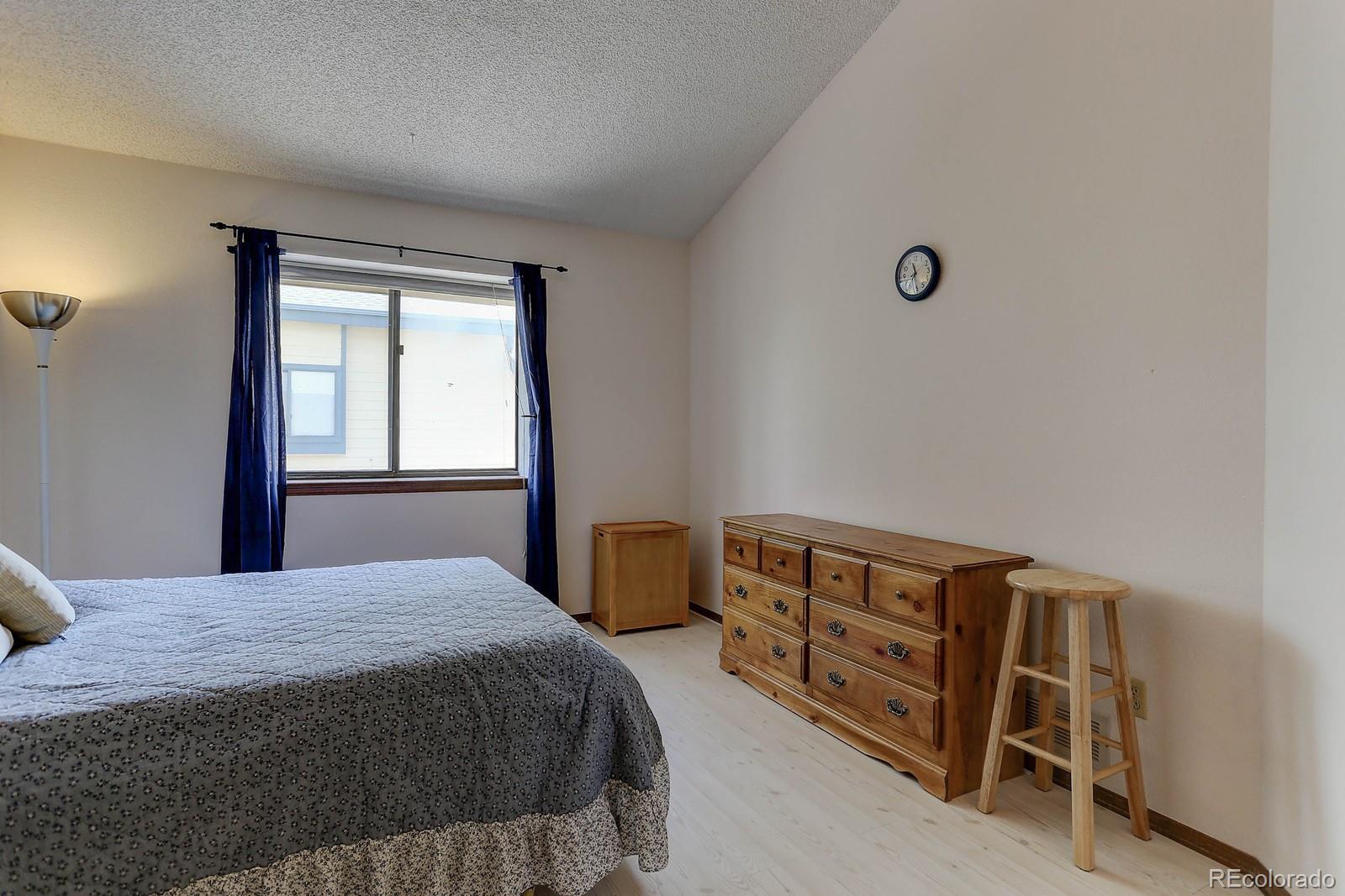 8794 Allison Drive, Unit B Arvada, CO 80005 - Photo 22 of 33 a bedroom with a bed and a window