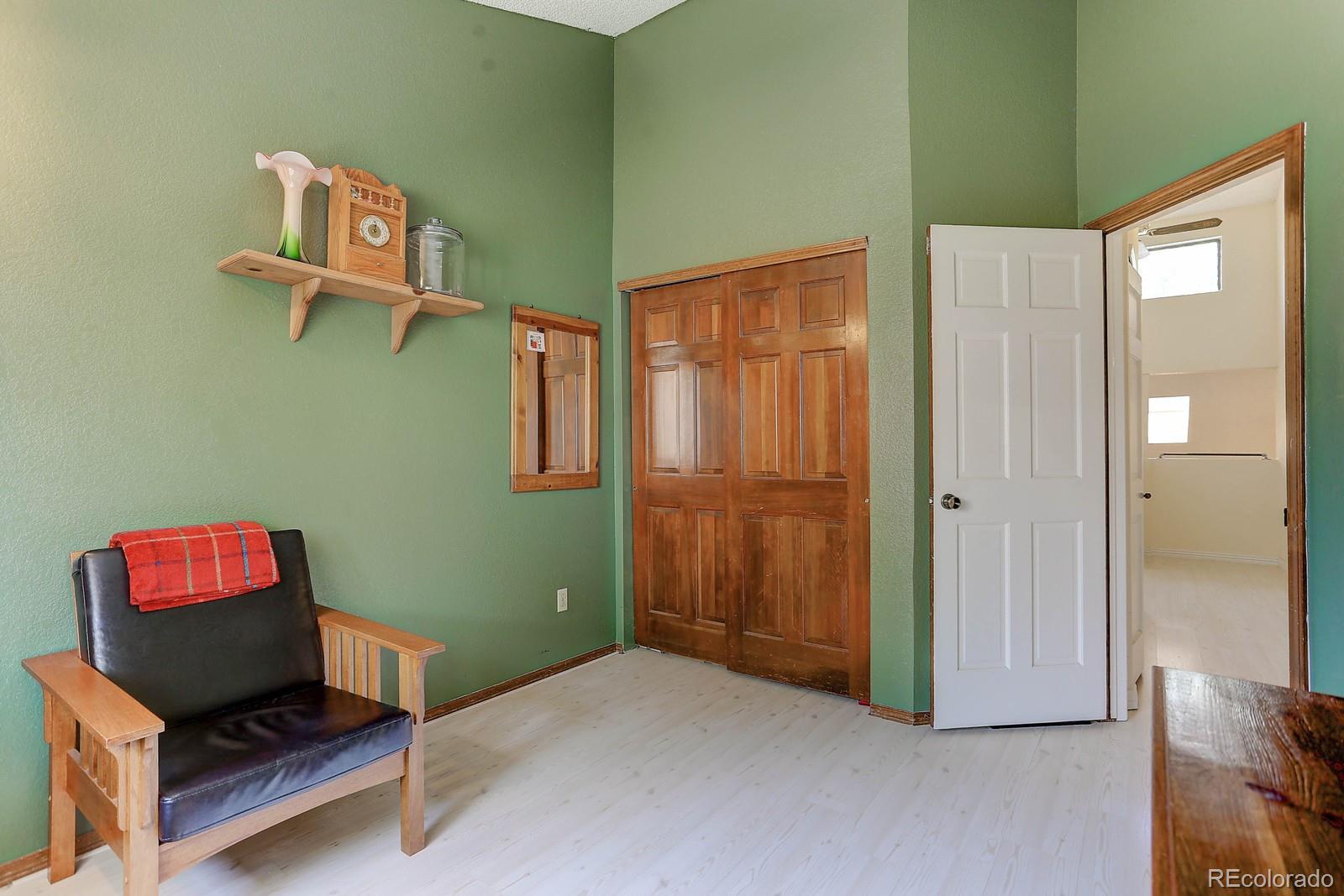 8794 Allison Drive, Unit B Arvada, CO 80005 - Photo 24 of 33 a living room with a bed and a window