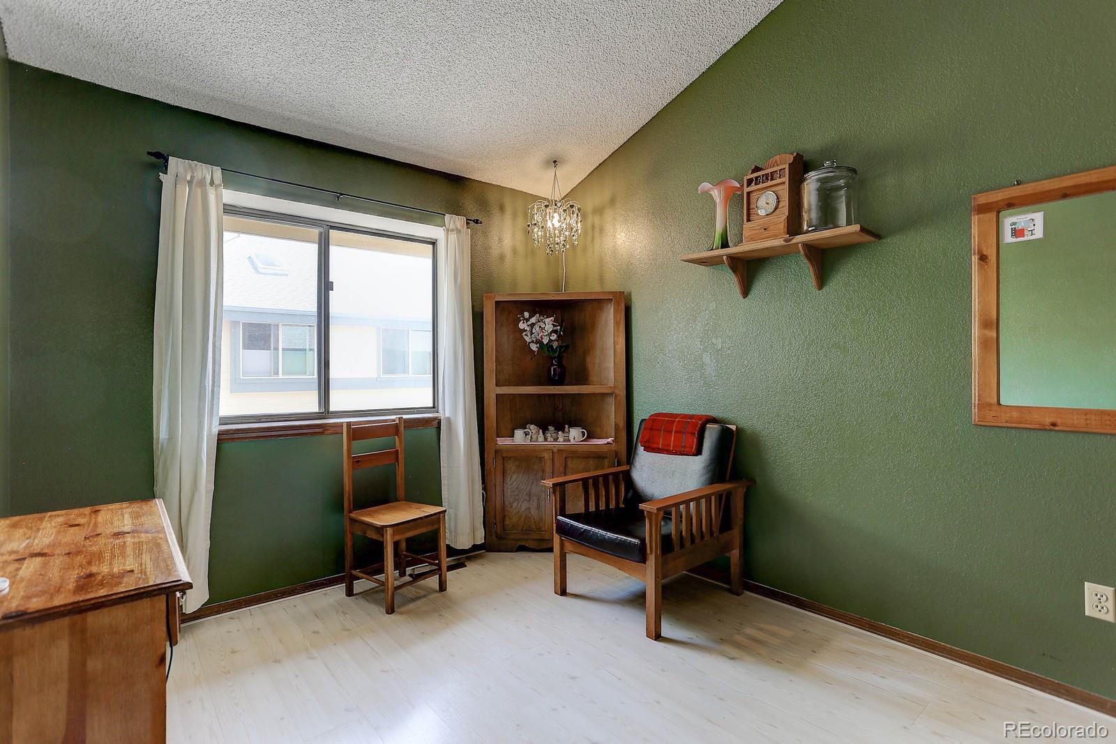 8794 Allison Drive, Unit B Arvada, CO 80005 - Photo 25 of 33 a living room with furniture and a window