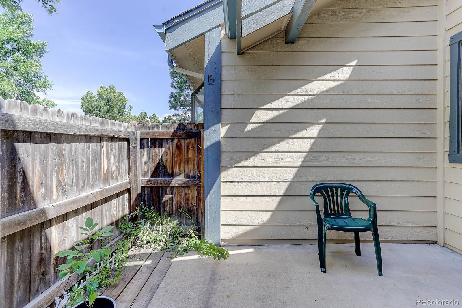 8794 Allison Drive, Unit B Arvada, CO 80005 - Photo 28 of 33 a view of a bench in patio with wooden fence