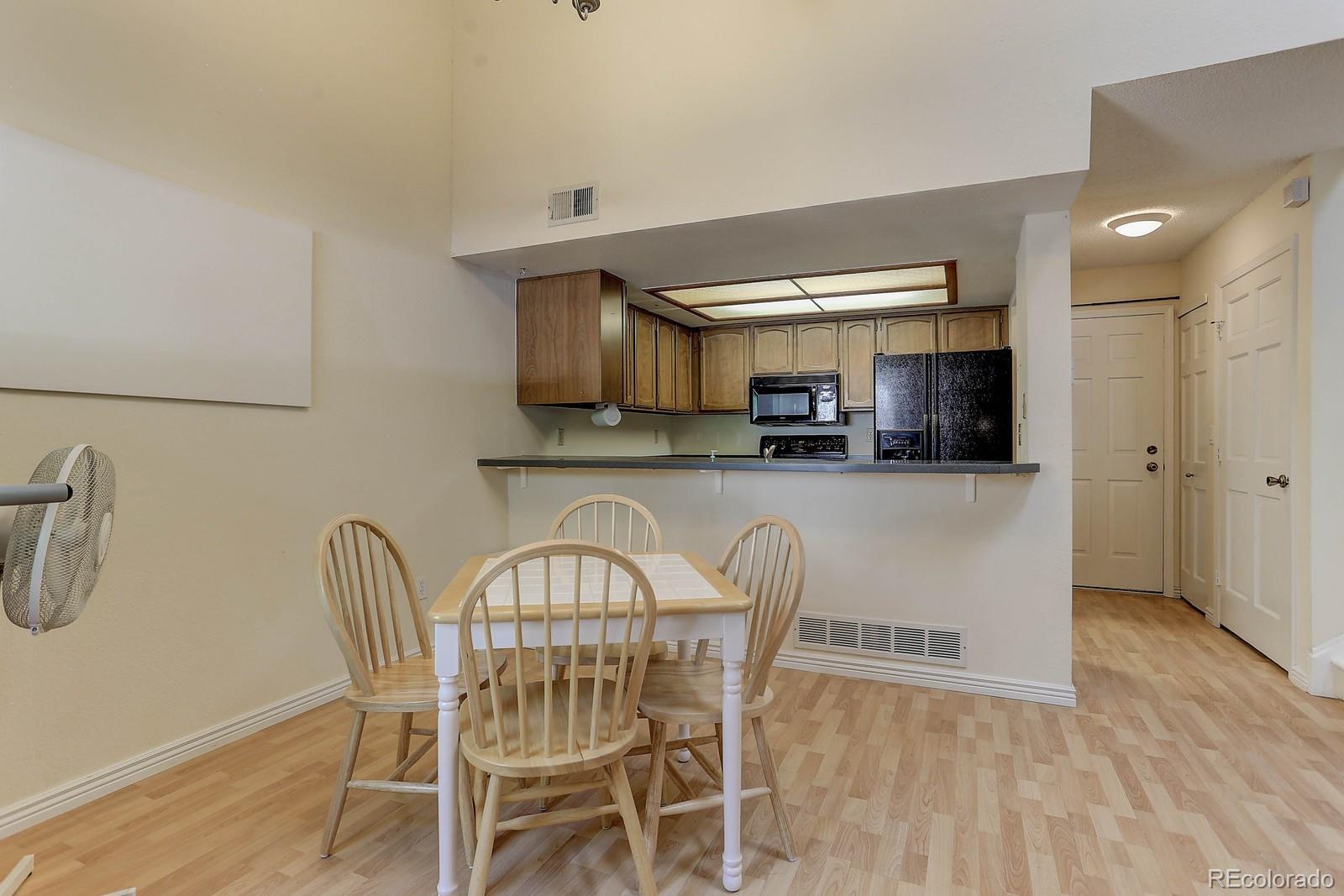 8794 Allison Drive, Unit B Arvada, CO 80005 - Photo 5 of 33 a view of a dining room with furniture and wooden floor