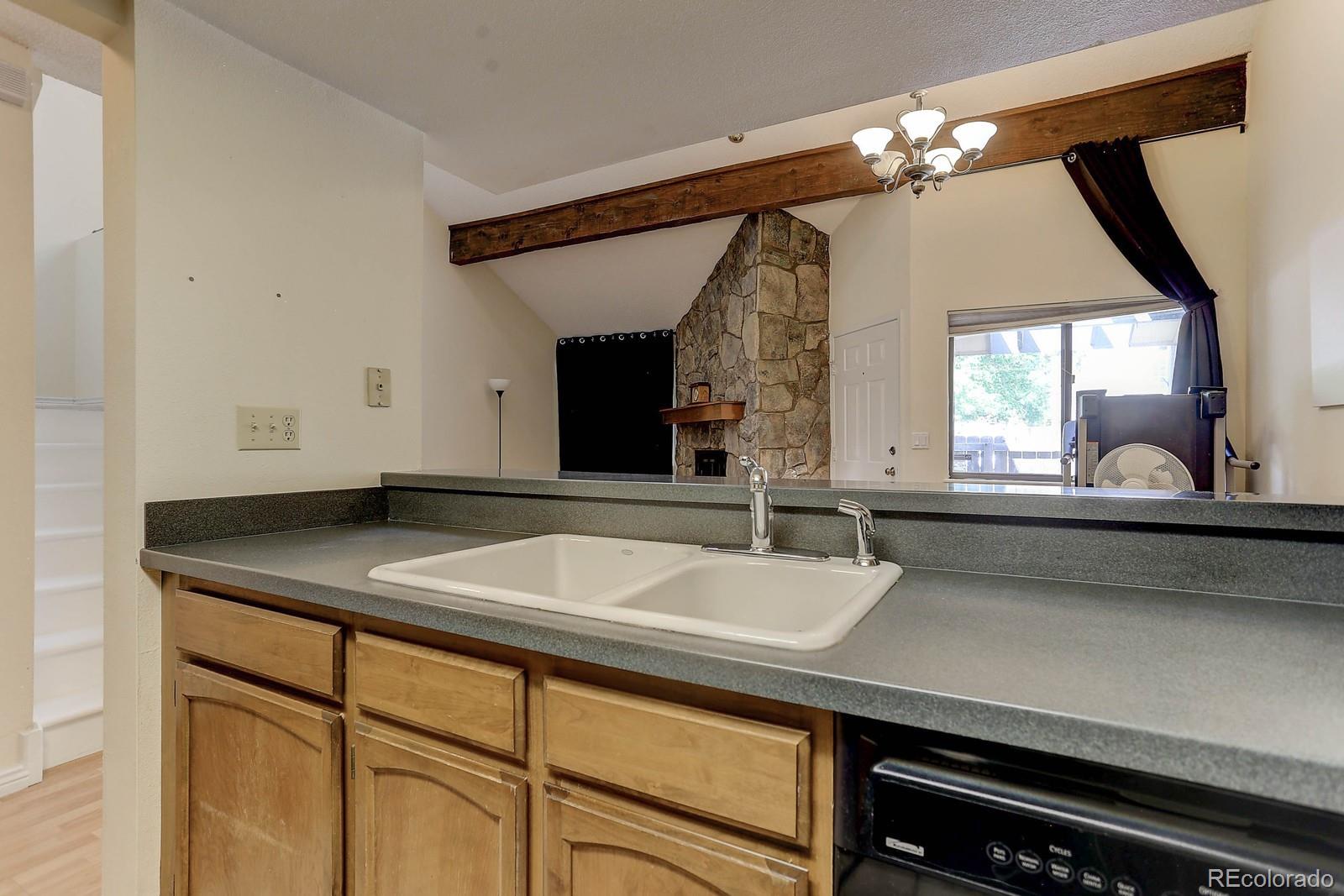 8794 Allison Drive, Unit B Arvada, CO 80005 - Photo 8 of 33 a bathroom with a sink and a large mirror