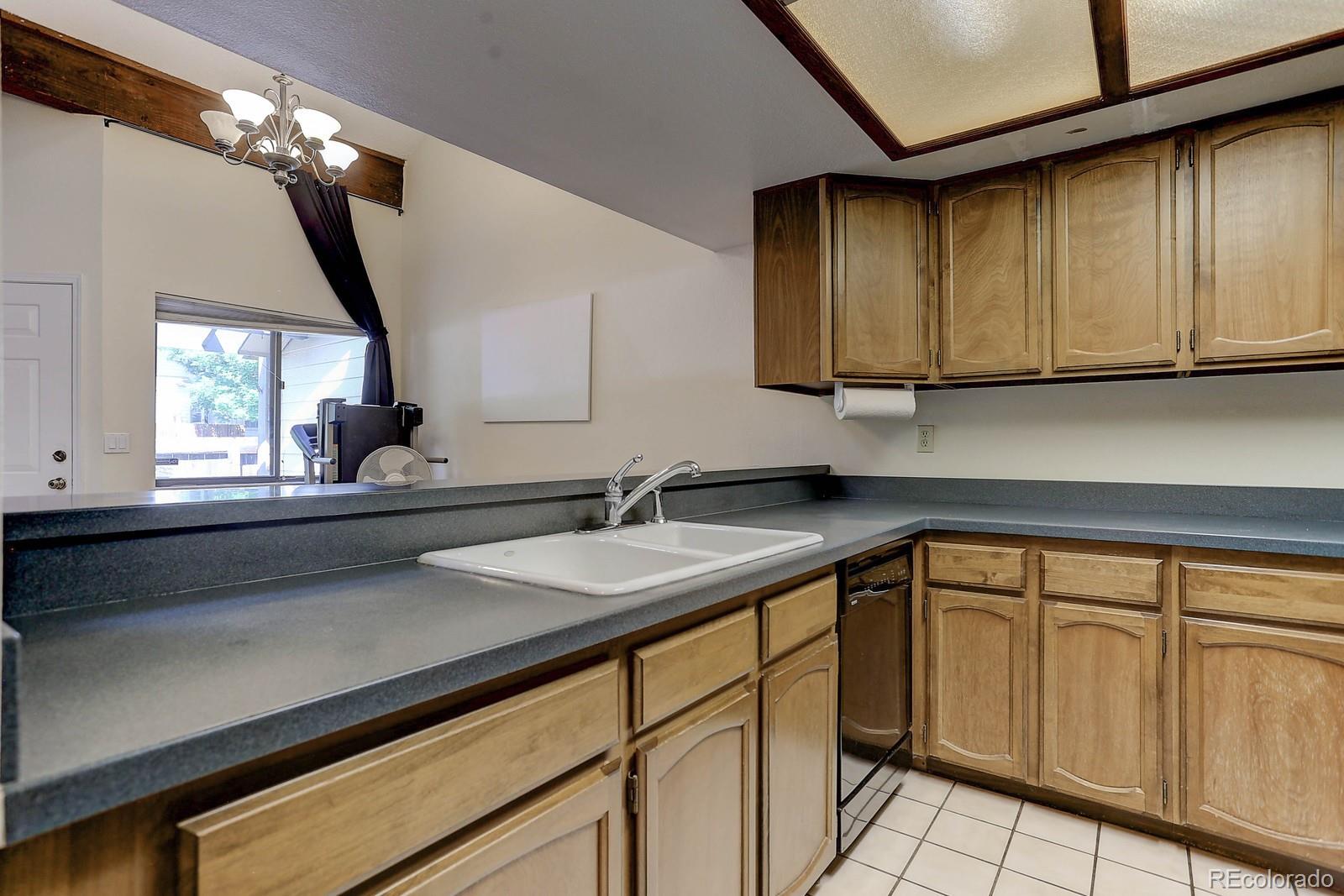 8794 Allison Drive, Unit B Arvada, CO 80005 - Photo 10 of 33 a kitchen with a sink and cabinets