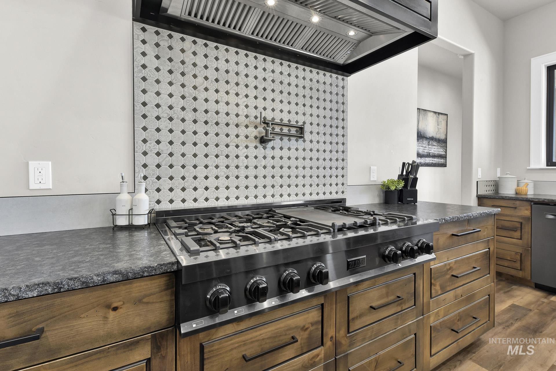 27114 Lower Pleasant Ridge Road Wilder, ID 83676 - Photo 13 of 50 Kitchen featuring custom range hood, stainless steel appliances, dark countertops, and dark wood-style flooring