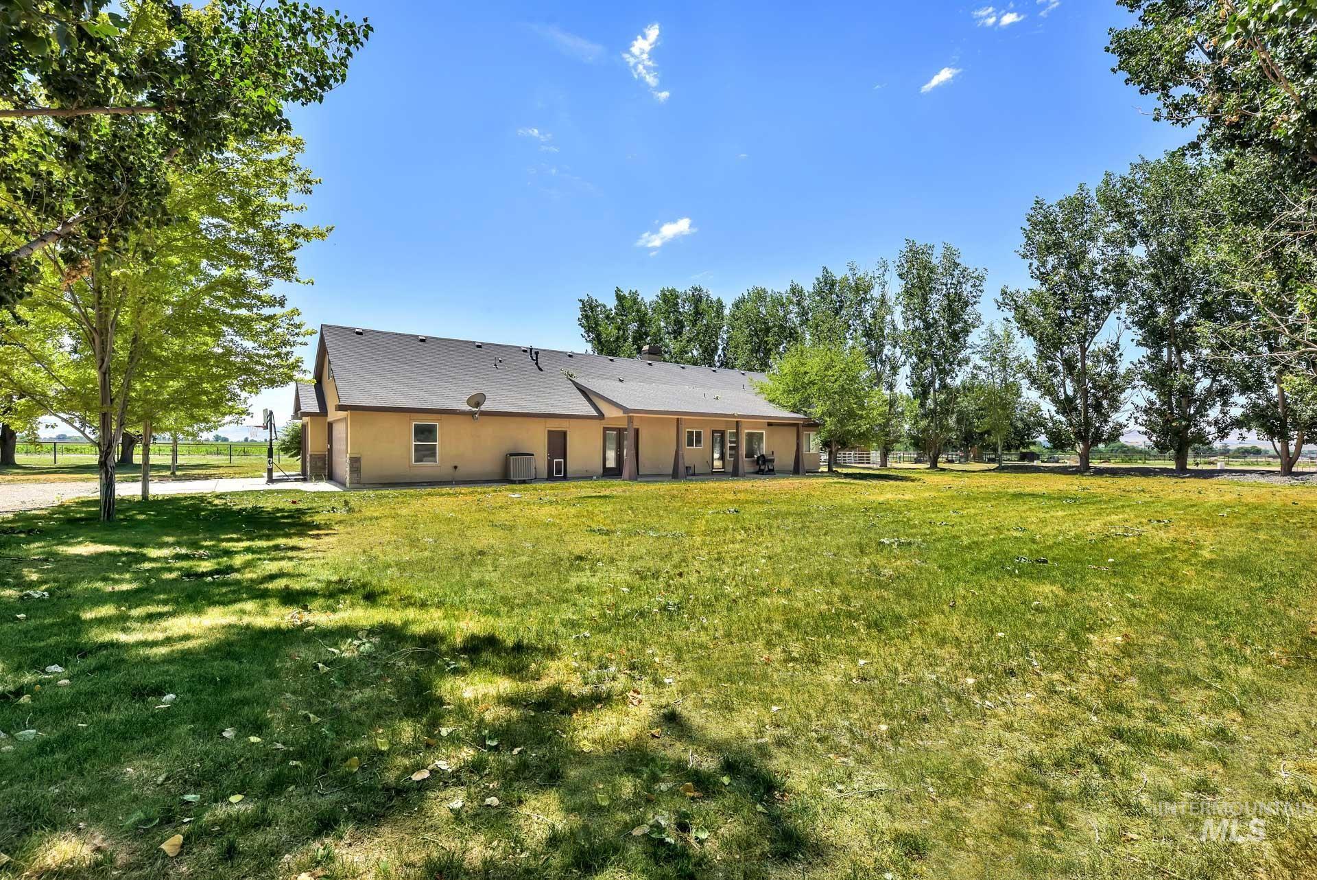 27114 Lower Pleasant Ridge Road Wilder, ID 83676 - Photo 24 of 50 Rear view of house featuring a lawn and stucco siding