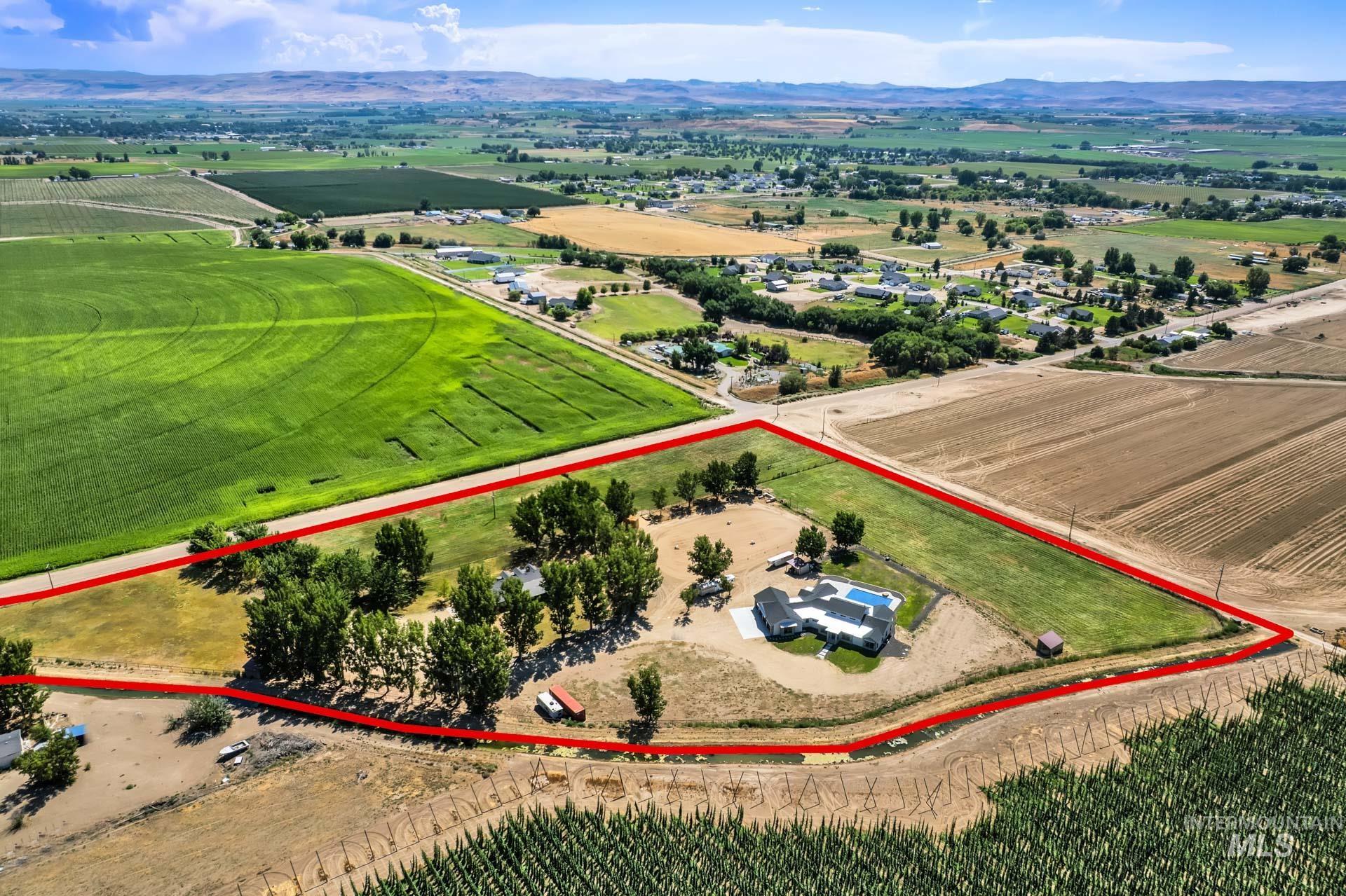 27114 Lower Pleasant Ridge Road Wilder, ID 83676 - Photo 46 of 50 Overview of rural landscape with property parcel outlined, large plots for crops, and a mountainous background
