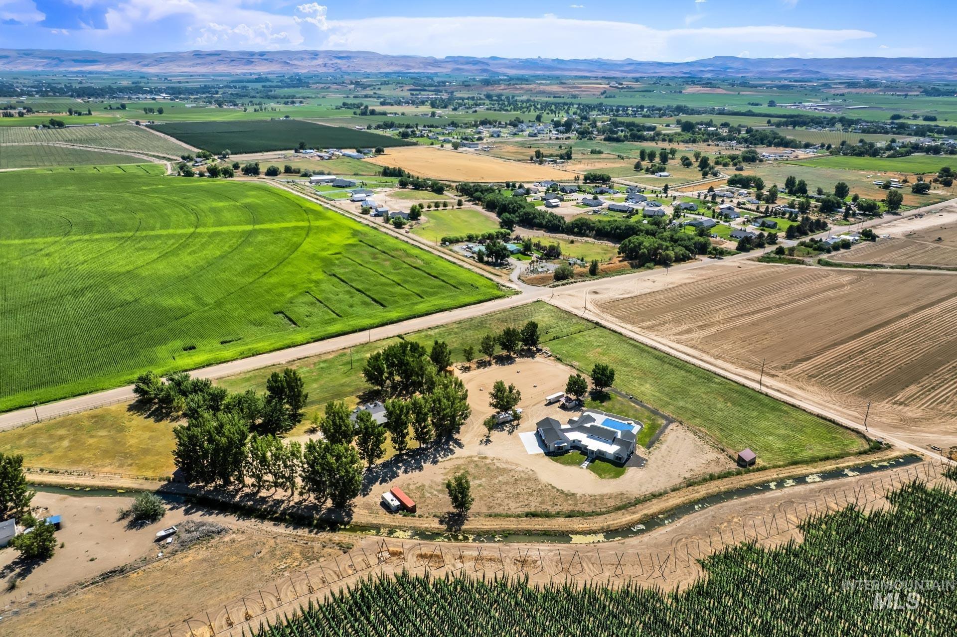 27114 Lower Pleasant Ridge Road Wilder, ID 83676 - Photo 47 of 50 Aerial view of sparsely populated area with abundant farmland and a mountainous background