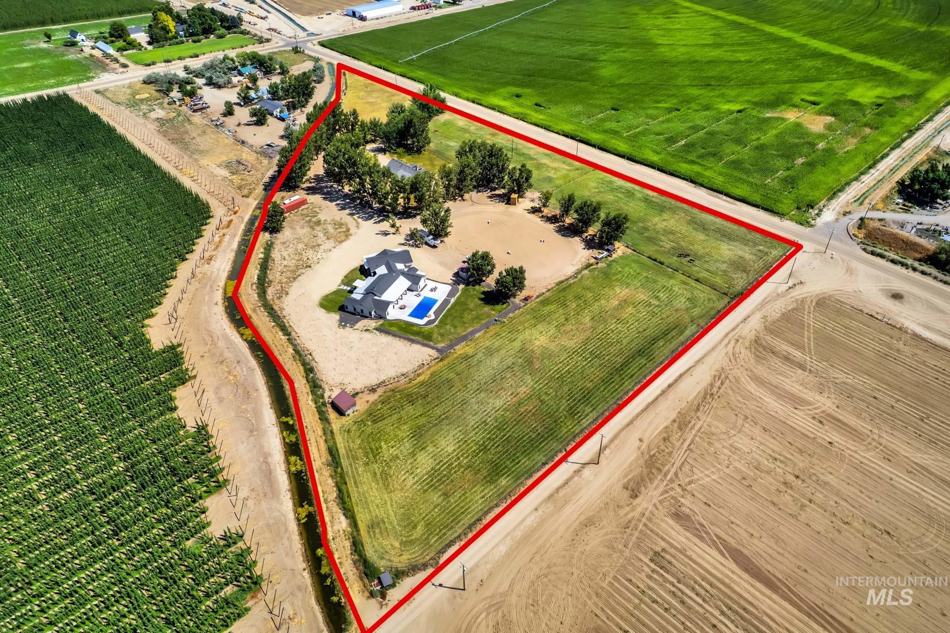 27114 Lower Pleasant Ridge Road Wilder, ID 83676 - Photo 5 of 50 Aerial view of sparsely populated area featuring property parcel outlined and abundant farmland