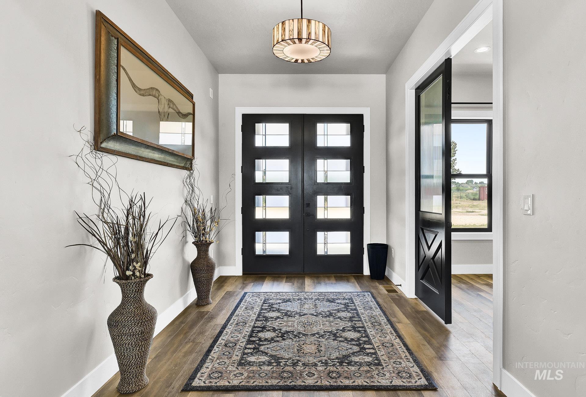 27114 Lower Pleasant Ridge Road Wilder, ID 83676 - Photo 8 of 50 Entrance foyer featuring dark wood-style flooring and french doors
