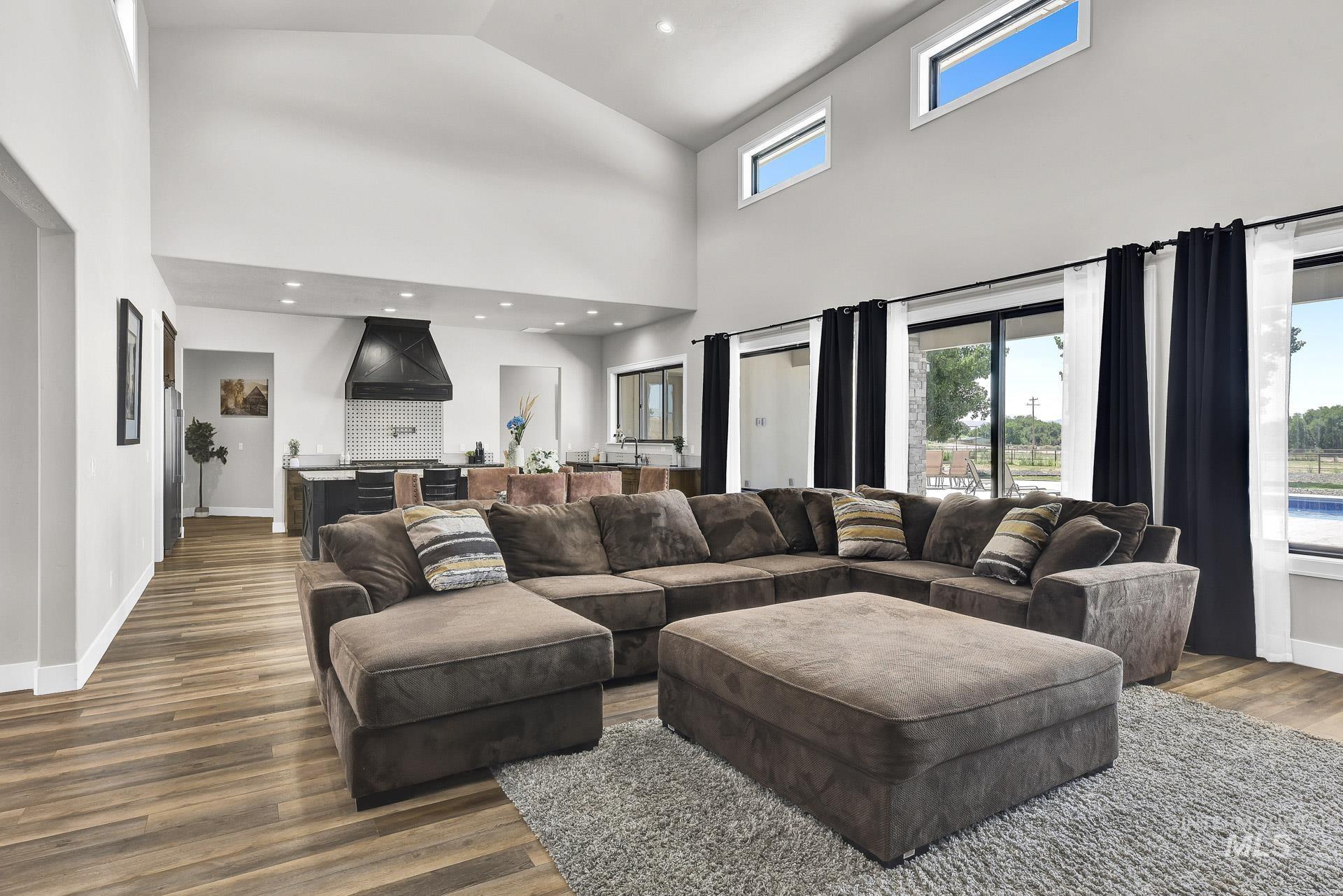 27114 Lower Pleasant Ridge Road Wilder, ID 83676 - Photo 9 of 50 Living room with wood finished floors, high vaulted ceiling, and recessed lighting