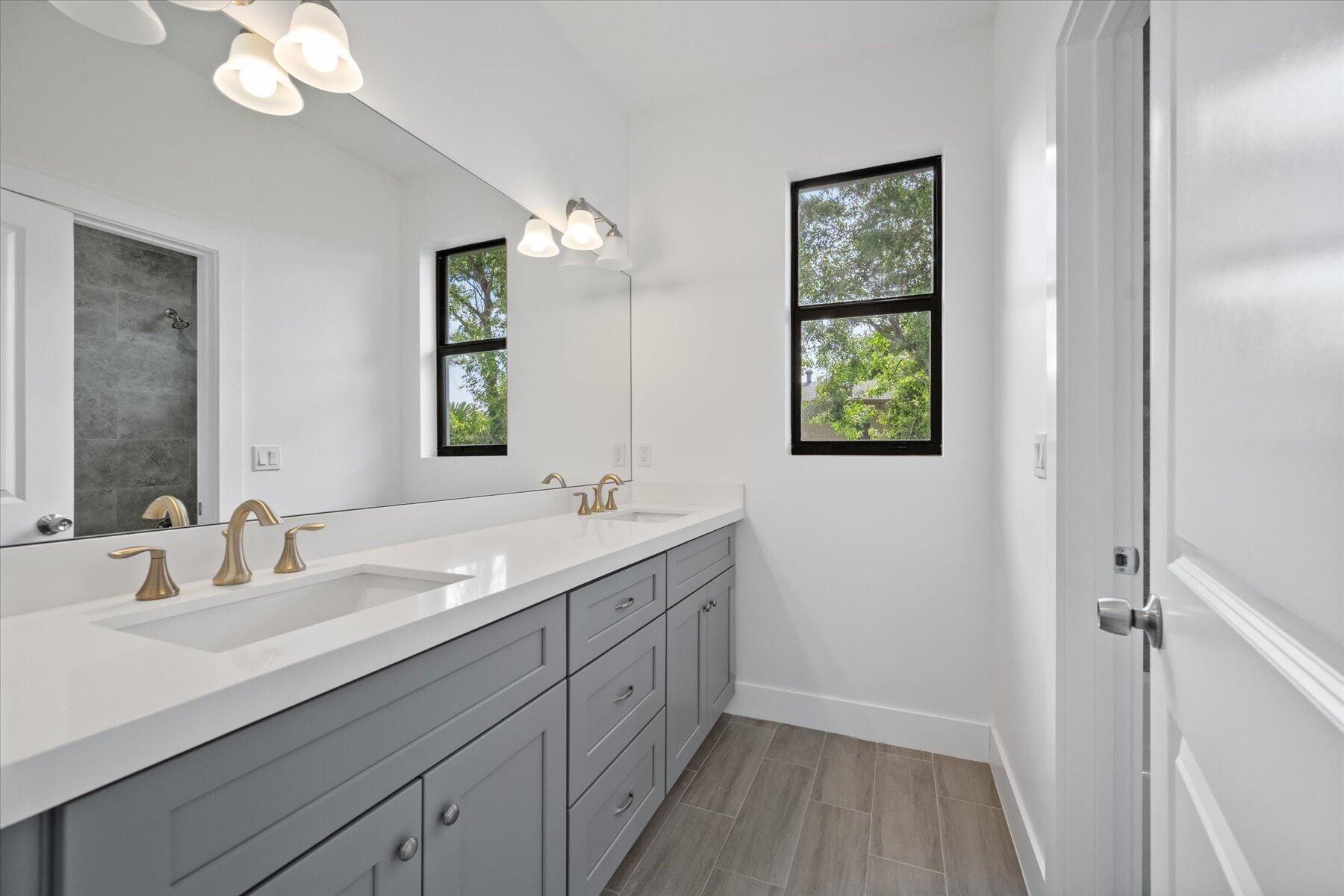 1491 West 30th Street Riviera Beach, FL 33404 - Photo 12 of 15 a bathroom with 2 sink and a mirror