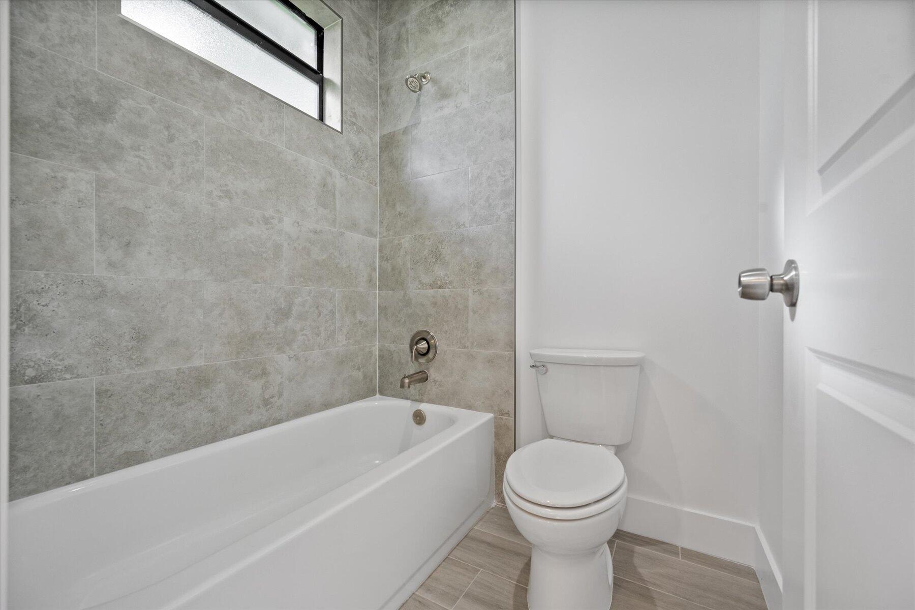 1491 West 30th Street Riviera Beach, FL 33404 - Photo 13 of 15 a bathroom with a toilet and a sink