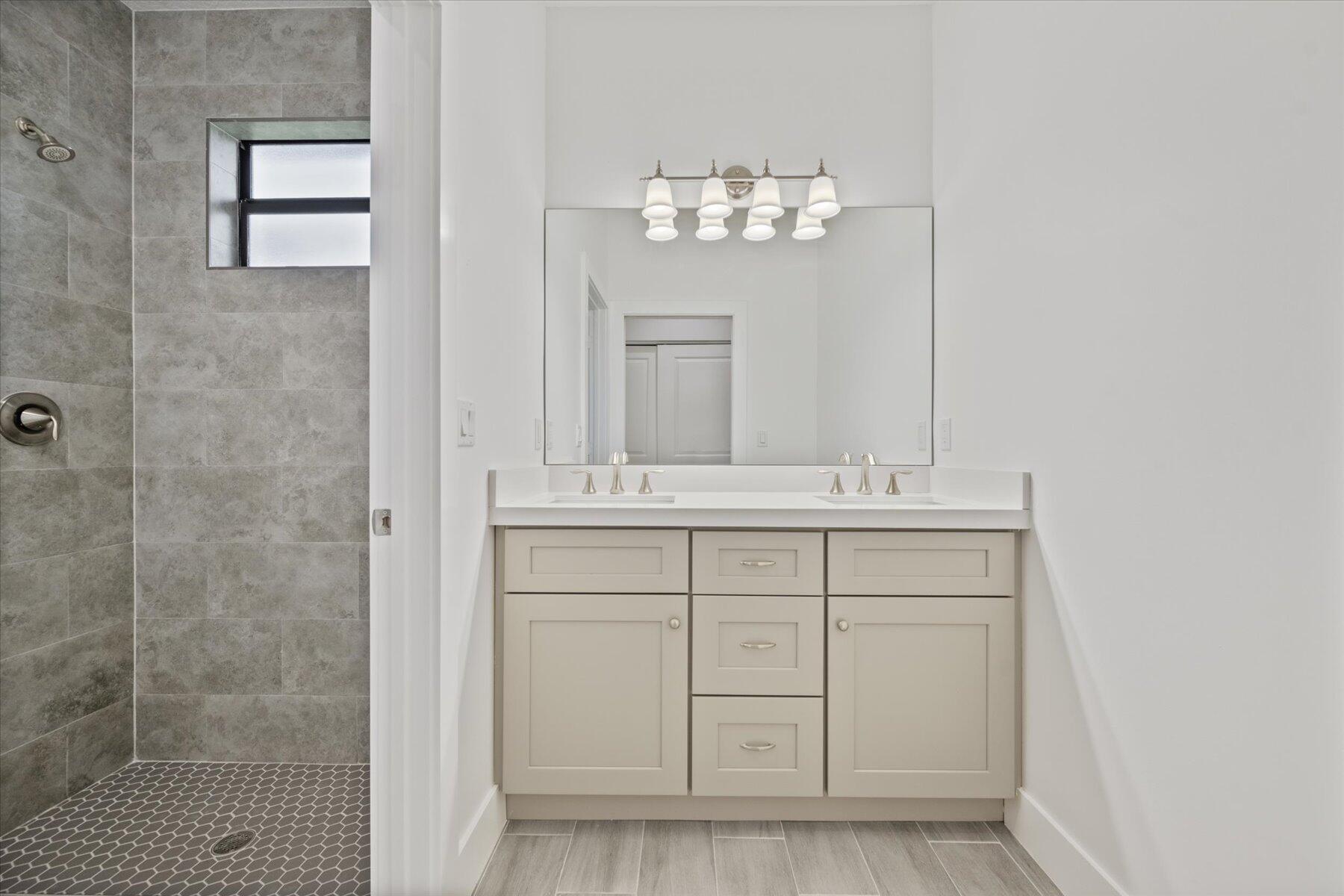 1491 West 30th Street Riviera Beach, FL 33404 - Photo 7 of 15 a bathroom with a sink a light fixture and a mirror