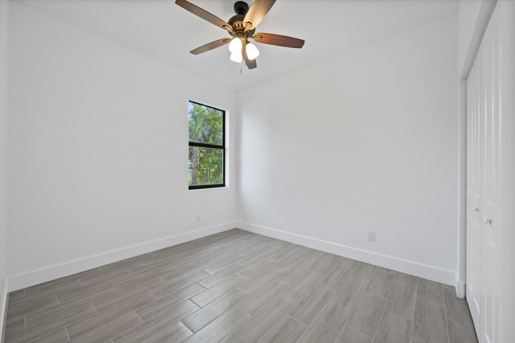 1491 West 30th Street Riviera Beach, FL 33404 - Photo 10 of 15 an empty room with a window and a fan