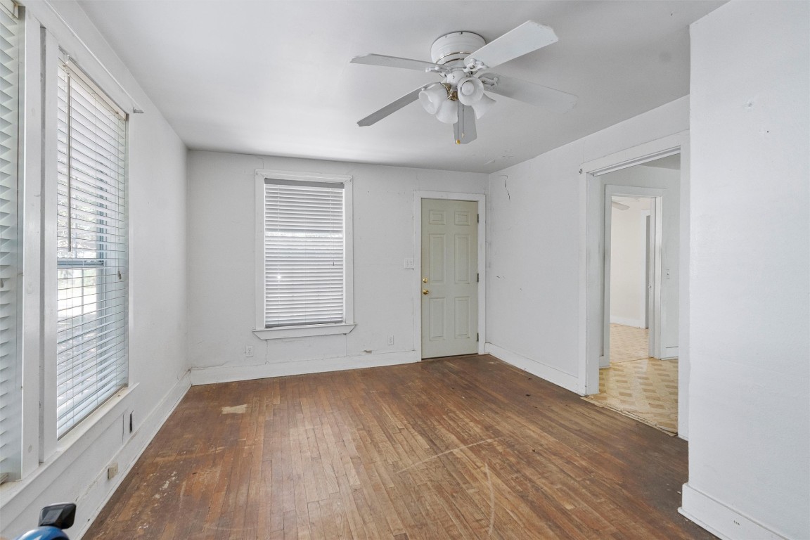 6311 Del Monte Road Austin, TX 78741 - Photo 13 of 24 a view of empty room with wooden floor and fan