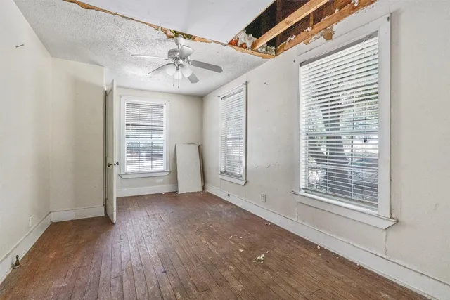 a view of a livingroom with wooden floor and a window