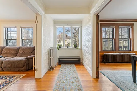 a living room with furniture a window and a fireplace