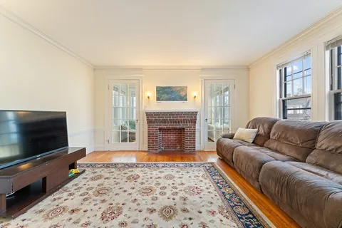 a living room with furniture and a floor to ceiling window