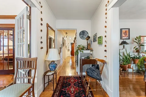 a picture of a living room with furniture and wooden floor