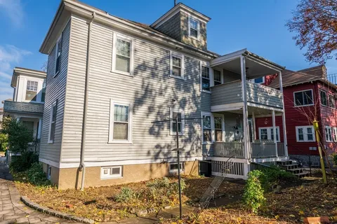 a view of a house with a tree in the yard
