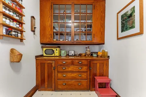 a bedroom with a bed a dresser and book shelf