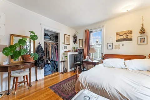 a bedroom with a bed and a book shelf