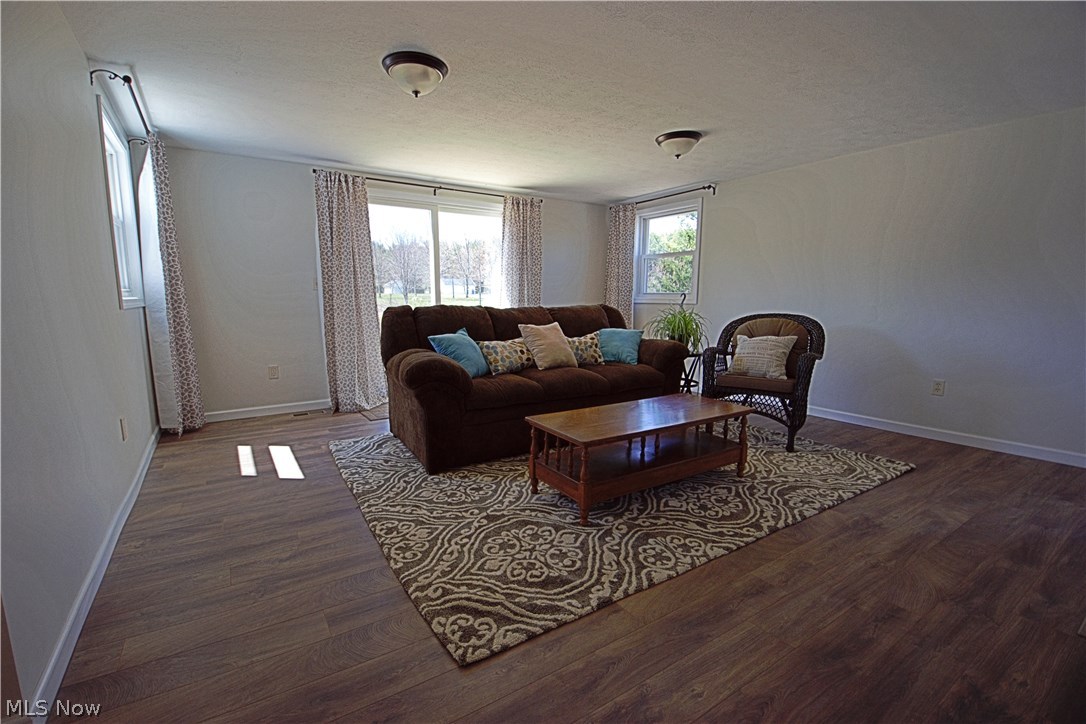 7670 Dewey Road Thompson, OH 44086 - Photo 19 of 34 Living room offers an area for all your entertaining needs with access to back deck.