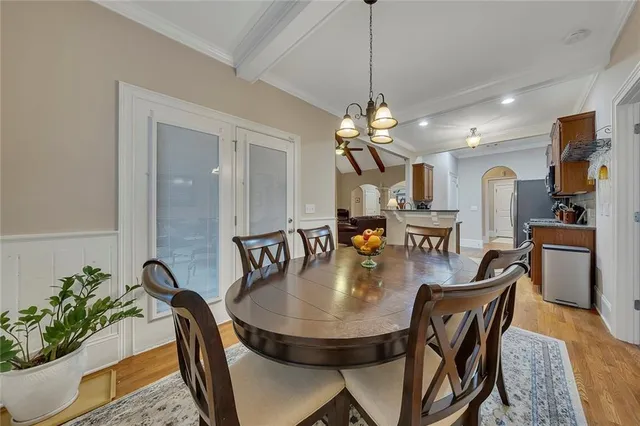 a bedroom with a large bed and a chandelier
