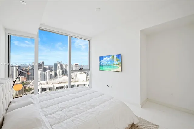 a bed room with a bed and a balcony