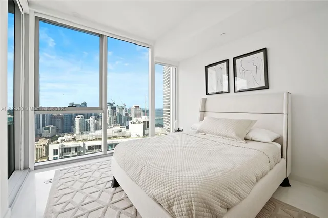 a bedroom with a large bed and a large window