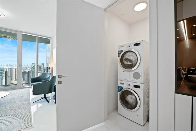 a view of a bedroom with washer and dryer