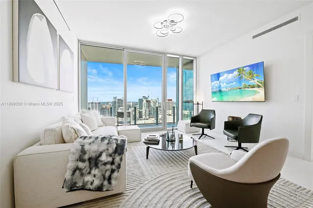 a living room with furniture and a large window