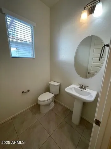 a bathroom with a sink toilet and mirror