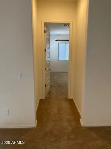 a view of a bathroom from a hallway