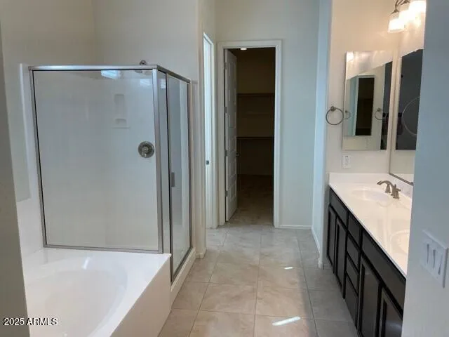a bathroom with a double vanity sink and a shower