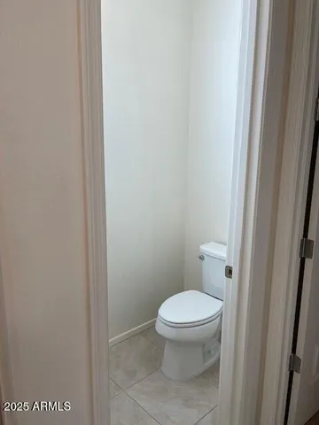 a white toilet sitting next to a shower