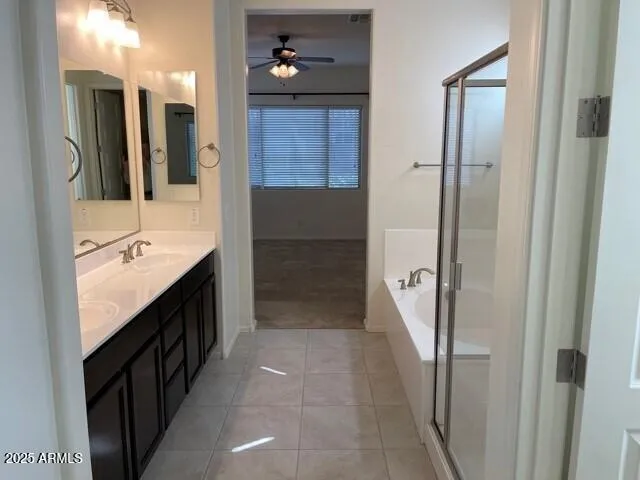 a bathroom with a double vanity sink a toilet and shower
