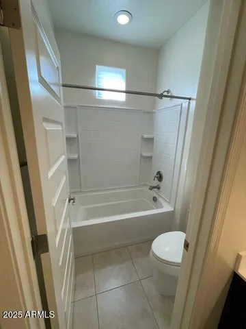 a view of empty room with ceiling fan