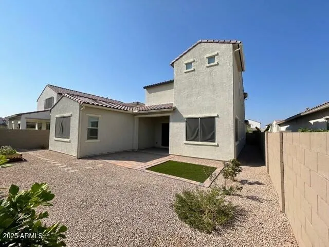 a view of a house with a small yard and a yard