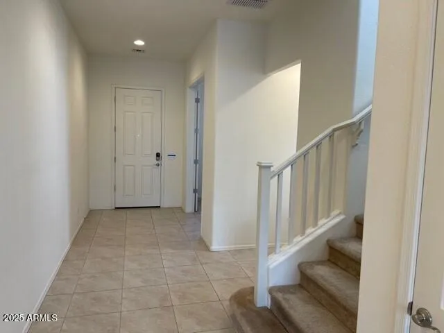 a view of entryway and hall with wooden floor