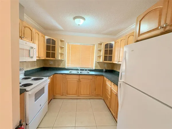 a kitchen with stainless steel appliances granite countertop a stove and a refrigerator