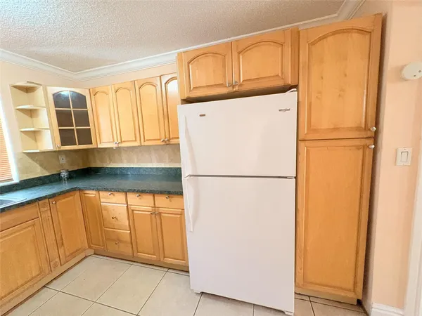 a white refrigerator freezer sitting in a kitchen