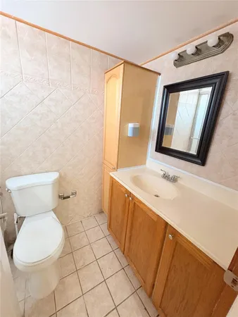 a bathroom with a sink mirror vanity and toilet